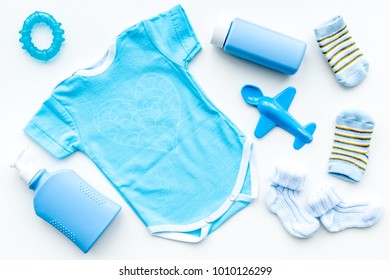 Blue Set For Newborn Boy. Baby Bodysuit, Socks, Airplan Toy, Soap And Powder On White Background Top View