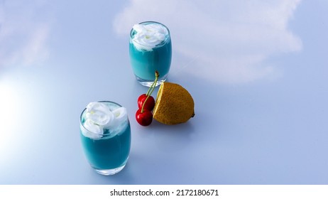 Blue Shake In Small Glasses Placed In A Place That Reflects The Sky