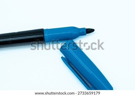 Blue Sharpie Permanent Marker Uncapped with Cap Beside on White