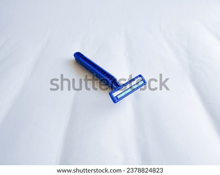 blue shaver isolated on white background with textured kinez.