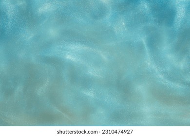 blue Shiny Abstract Background. Paints, Acrylic, Glitter in Water. blue Shiny Liquid Surface, Ripples, Waves.