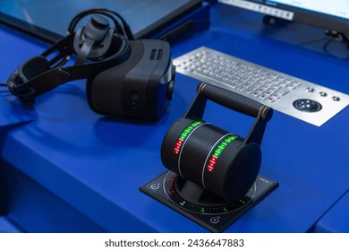 Blue ship control panel with engine accelerator in full ahead position and VR headset on it. Marine navigation simulation system equipment