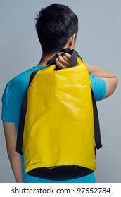 Blue Shirt Man Carry A Yellow Waterproof Bag