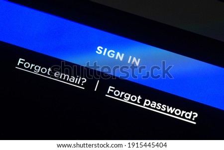 Blue sign in button on LCD screen, login web page, two links for forgotten email and password.