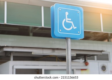 Blue sign with symbol of person sit on wheelchair. Parking for disability persons sign. Service as privileges for handicap to park car at public park or gas station.                               