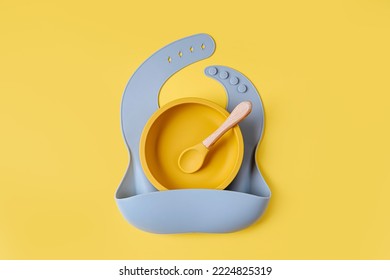 Blue Silicone Baby Bib And And Bowl. Serving Baby. First Baby Accessories For Dinner.  Top View, Flat Lay