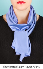 Blue Silk Scarf Around Her Neck Isolated On Blue Background. Female Accessory.