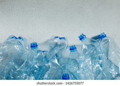 Blue single use plastic bottles. Concept of Recycling plastic and ecology. Flat lay, top view   - Shutterstock ID 1426755077