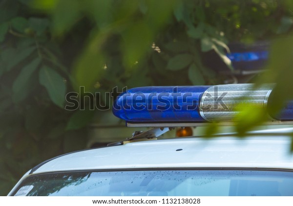Blue siren flasher on the\
police car. Flash light and siren on the emergency car. Police\
signal.