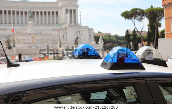 blue sirens of an italian police car in the\
Venice Square in Downtown of Rome in\
Italy