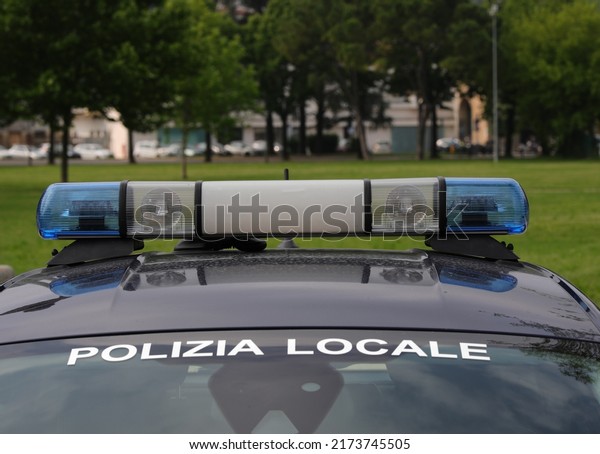 Blue sirens\
of the police car while patrolling the public park the writing in\
Italian which means Local\
Police