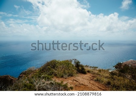 blue skies and clouds and pacific ocean view from mountain peak on tropical hawaiian island