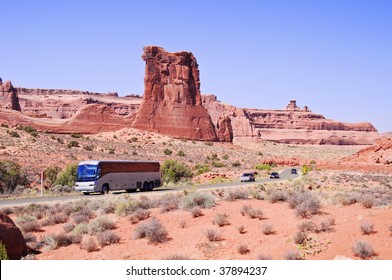 Blue Skies And Sunny Day At Arches Canyon, Luxury Motorcoach Bus Tour,Utah. USA. Beautiful American Usa Tourist National Park. Bus Coach Holiday Driving Through Arches National Park In America Usa.