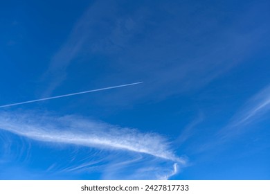 Blue sky and airplane contrails - Powered by Shutterstock