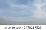 Blue sky background with foggy clouds in atmosphere
