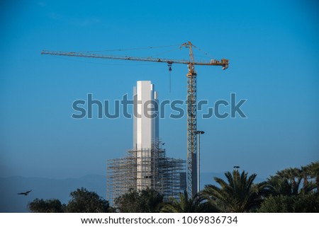 Blue sky background, uilding crane and tower under construction