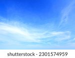 blue sky background and white clouds streaks below use as backdrop