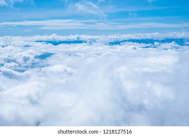 Blue sky background with white clouds.