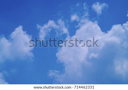 Blue sky background with white clouds.