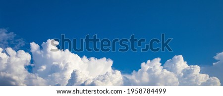 Blue sky background. Wide panorama with cumulus clouds at the bottom of the photo