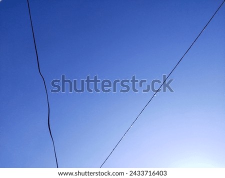 Blue sky and black wires an