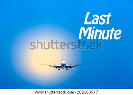 Blue sky and blurred yellow light with an airplane on landing approach in front of it with textual message/Air Travel - Last Minute
