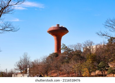 Blue sky and brown rusty UFO-like water tower