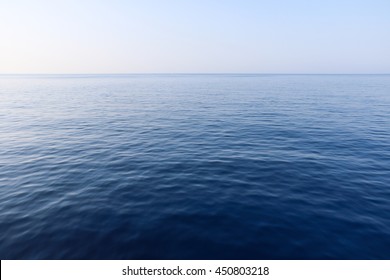 Blue sky and calm ocean sea water background