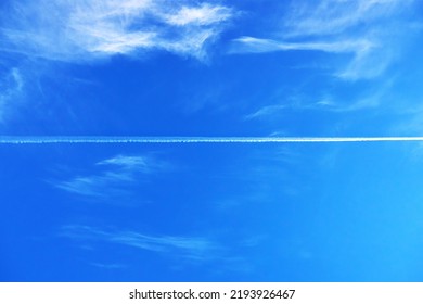 In The Blue Sky With Cirrus Clouds, You Can See The Trace Of The Flying Plane, The Natural Background.