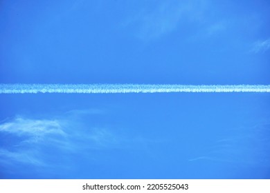 In The Blue Sky With Cirrus Clouds, You Can See The Trace Of The Flying Plane, The Natural Background.