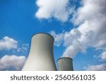 Blue Sky and Clouds Above Industrial Cooling Towers