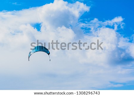blue sky with clouds and parachute