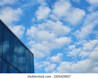 The blue sky and clouds reflected the sky the windows the building