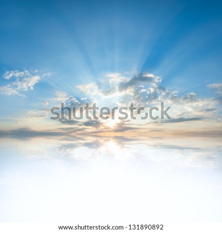 Blue sky with clouds and sun reflection in water with place for your text