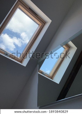 blue sky and clouds in the window and in the mirror image