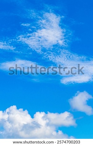 Blue sky with comparison real clouds chemical clouds chemical sky and chemtrails on sunny day in Playa del Carmen Mexico.