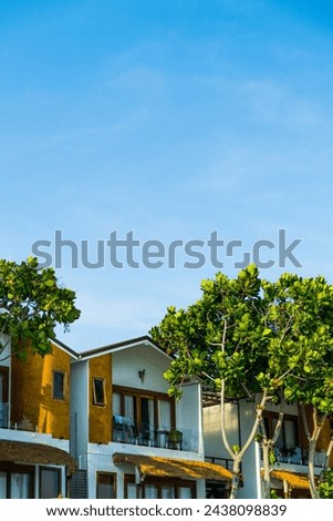 blue sky, daylight, shading light, trees, summerhouse at daylight on the beach.