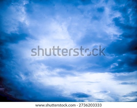 The blue sky was filled with thick clouds with bright light emerging from behind them, making the atmosphere feel dramatic like it was about to rain.