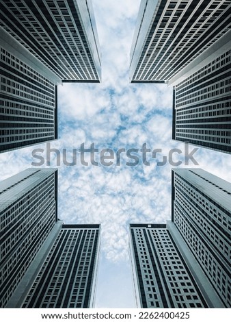The blue sky frame above the building is viewed from a low angle.