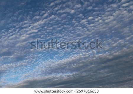 blue sky with heave cloudscape of cirrocumulus flocus clouds in white and grey