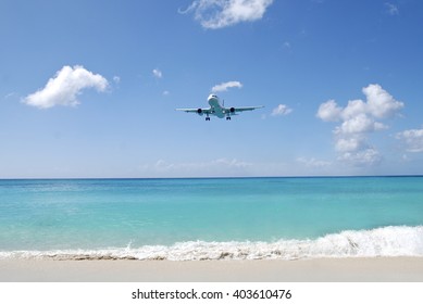 Blue sky, Horizon with an Airplane flying with clouds. Beach 