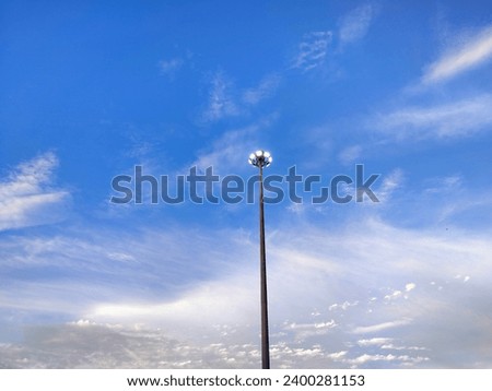 The blue sky and light poles rely on it to decorate and add beauty. nature and man made Live together perfectly