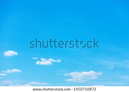 Blue sky with light white clouds -  background with large copy-space on the top