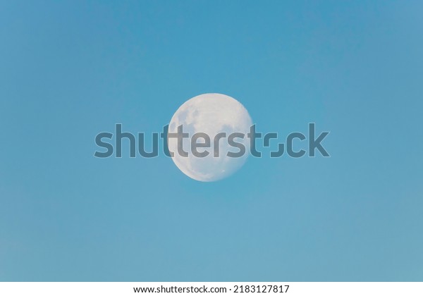 Blue sky and moon rising in the late afternoon\
over Sydney, NSW,\
Australia.