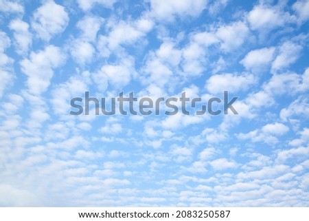 Blue sky with multitude small clouds , may be used as background or texture