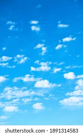 Blue sky with multitude of white clouds - vertical background - Shutterstock ID 1891314583