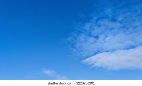 Blue sky with occasional clouds. Autumn day high in the sky are translucent white cirrus clouds. They are blurry translucent and have different shapes and sizes. - Shutterstock ID 2220936301