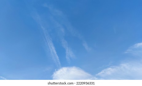 Blue sky with occasional clouds. Autumn day high in the sky translucent white cirrus and cumulus clouds. They are blurry translucent and have different shapes and sizes. - Shutterstock ID 2220936331