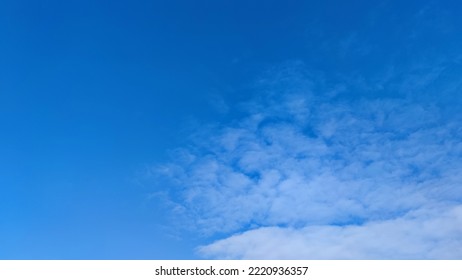 Blue sky with occasional clouds. Autumn day high in the sky are translucent white cirrus clouds. They are blurry translucent and have different shapes and sizes. - Shutterstock ID 2220936357