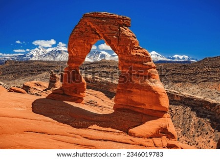 Blue sky over the iconic Delicate Arch, a geological wonder of time and erosion.  Located in Arches National Park near Moab in central Utah, United States.